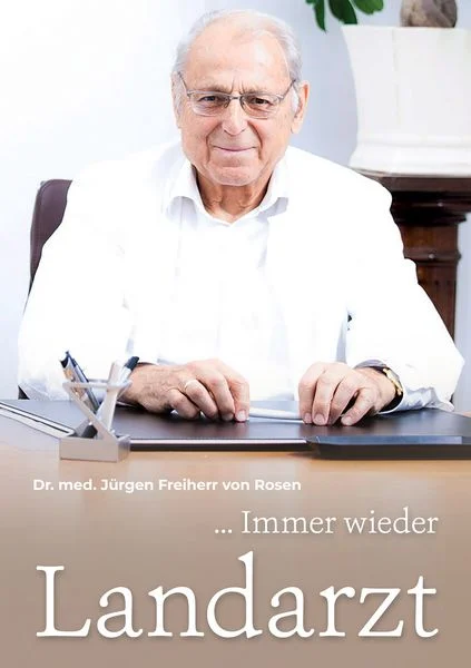 Bild von einem Arzt im weißen Kittel, der am Schreibtisch sitzt